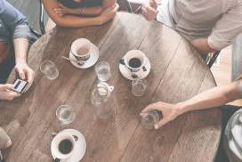 Friends around a coffee table talking about interest rates
