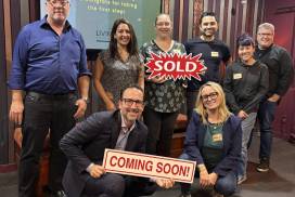 Living CA Realty Home Buying Seminar in Long Beach with some of the attendees with a sold sign after the event